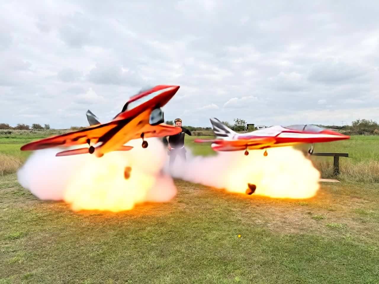 Pika 2.2 Image to Video AI video example: the jets start to hover and flames come out, the 2 men look shocked and scared and start to run...